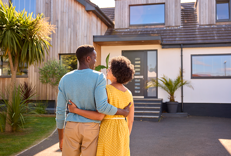 Couple happily looks at their new rental property purchase